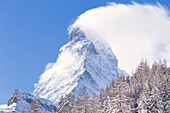 The Matterhorn wrapped by clouds after a snowfall. Zermatt, Canton of Valais / Wallis, Switzerland.