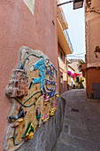 Decorated wall of old alley, Porto Azzurro, Elba Island, Livorno Province, Tuscany, Italy