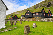 Traditional houses with grass roof and cemetery, Kirkjubour, Streymoy island, Faroe Islands, Denmark