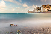 beach and the natural rock arch porte d'Amont at Etretat, Normandy, France