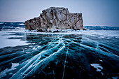 Ice cracks towards to an island at lake Baikal, Irkutsk region, Siberia, Russia
