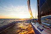 View from onboard of trimaran at sunset, Atlantic Ocean, Brittany, France