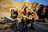 Mountain Biker at Red Bull Rampage sitting at sunset, Utah, USA