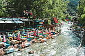 View of Ourika River and restaurants with tables in water, Ourika, Marrakesh, Morocco