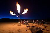 A homemade flame effects shoots propane fireballs into the night sky at the High Sierra Fly In event int eh Nevada Desert