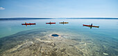 Kayakers passing by underwater geyser of Yellowstone Lake, Yellowstone National Park, Wyoming, USA