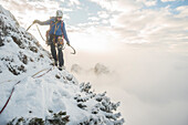 Lone male mountain climber in winter in Tatra Mountains, Malopolskie Province, Poland
