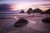 tidal pool in the midnight sun on a sandy beach near the city of Sto, Vesteralen islands, Norway