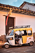 parking Tuk Tuk in front of colonial building where christmas decoration was mounted, Barichara, Departmento Santander, Colombia, Southamerica