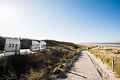 Beach chairs and blue sky in winter, East Frisian Islands, Spiekeroog, Lower Saxony, North Sea, Germany