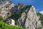Hut rifugio Bietti standing beneath rock face, hut rifugio Bietti, Grigna, Bergamasque Alps, Lombardy, Italy