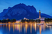 City of Lecco, illuminated, with Grigna in background and lake lago di Como in foreground, Lecco, Grigna, Bergamasque Alps, Lombardy, Italy