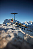 two women on Hahnkampl peak  Lamsenspitze in the back ,  Eastern Karwendel Range, Tyrol, Austria