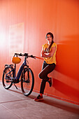 Young  woman in front of a modern facade, Munich, bavaria, germany