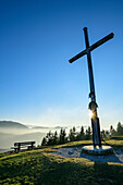 Bench and cross at summit of Zwieselberg, Zwieselberg, Bavarian Alps, Upper Bavaria, Bavaria, Germany