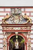 emblem above archway, historic buildings at market place of Coburg, Upper Franconia, Bavaria, Germany