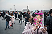 chinese woman with selfie stick and pink jewellery using mobile phone,  waiting for flag ceremony and  changing of the Guards at Tiananmen Square, Beijing, China, Asia