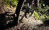 Rear wheel of a mountainbike in deep mud, sprinkling dirt, Tyrol, Austria
