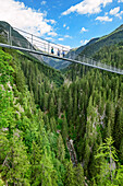 Several persons walking on suspension bridge, Holzgau, Lechweg, valley of Lech, Tyrol, Austria