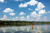 Young woman bathin in lake Ostersee, Upper Bavaria, Germany, Europe