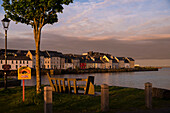 The sunset paints the sky pink over the famous Long Walk with its row of beautiful coloured houses situated at the Corrib Harbour, Galway, County Galway, Ireland, Europe