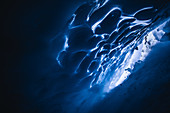 Snowboarder rides in an ice cave, Pitztal, Austria,