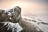 Bizarr rock formations at Ipf mountain (outlier) in winter with fog, Bopfingen, Ostalb District, Swabian Alb, Baden-Wuerttemberg, Germany