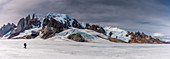 Mountaineer on ice surface of the Campo de Hielo Sur, panorama with Cerro Torre, Los Glaciares National Park, Patagonia, Argentina