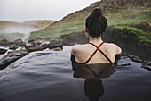 Rear view of woman in hot pool Iceland