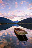 Boat moored in lake of Novate Mezzola at sunrise, Valchiavenna, Sondrio province, Valtellina, Lombardy, Italy