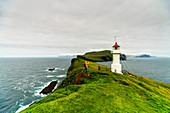 Hiker at the lighthouse, Mykines island, Faroe Islands, Denmark