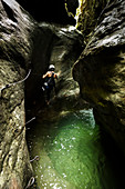 a hiker is climbing along the Stretta di Luina klettersteig, Casto, Brescia province, Lombardia, Italy