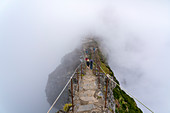 People descending the steps on the trail at Pico do Areeiro. Funchal, Madeira region, Portugal.