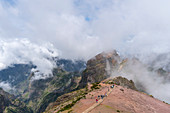 People walking on the trail at Pico do Areeiro. Funchal, Madeira region, Portugal.