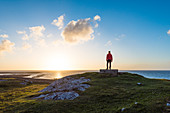 A man admiring the sunset. Fanad Head, County Donegal, Ulster province, Ireland, Europe.