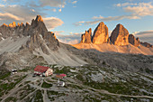 Sunset on Paternkofel and Drei Zinnen with Locatelli-Innerkofler refuge, Dolomites, Dobbiaco, South Tyrol, Bolzano, Italy