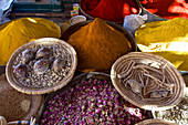 Colored spices, powder, dried roses and clams at the market in Rissani, Tafilalet, Morocco