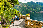 Woman on park bench at Villa del Balbianello by Lake Como, Italy