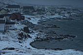 View of town on icy coastline, Twillingate, Newfoundland, Canada