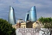 View from the old town with renovated houses to the Flame Towers with its blue glass facade, Baku, Caspian Sea, Azerbaijan, Asia