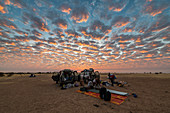 Camping under a dramatic morning sky in the Sahel, Chad, Africa