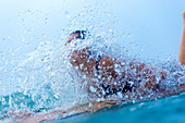 View of female surfer in sea behind splashing water