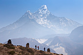 Three hikers descending from Pangboche monastery to continue their hike to Everest Base Camp, in the background Ama Dablam mountain. The trek to Everest Base Camp (EBC) is possibly the most dramatic and picturesque in the Nepalese Himalaya. Not only will you stand face to face with Mount Everest, Sagarmatha in Nepali language, at 8,848 m (29,029 ft), but you will be following in the footsteps of great mountaineers like Edmund Hillary and Tenzing Norgay. The trek is scenic and offers ever-changing Himalayan scenery through forests, hills and quaint villages. A great sense of anticipation builds