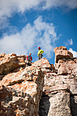 View up two rock climbers standing atop Corbet's Couloir, Jackson, Wyoming, USA
