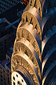 Sunset light hits the top of the Chrysler Building in Midtown Manhattan, New York. Completed in 1930, the building was the tallest in the world for a brief time until it was overtaken by the Empire State Building, completed a year later. Today, the Chrysler Building remains one of the tallest and most iconic in New York City.
