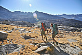 Backpackers hike to Knapsack Pass near Columbine Mountain in Palisade Basin on a two-week trek of the Sierra High Route in Kings Canyon National Park in California. The 200-mile route roughly parallels the popular John Muir Trail through the Sierra Nevada Range of California from Kings Canyon National Park to Yosemite National Park. 