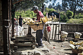 Miner weighting his baskets full of sulfur rocks from Kawah Ijen Volcano, Java, Indonesia