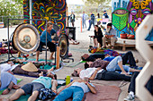Music festival goers relaxing and enjoying sound bath, San Bernardino County, California, USA