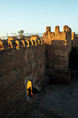 A man walks through of the arches in the city wall in Taroudant (Morocco)