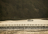 Boat on tranquil river, Arashiyama Park, Nakanoshima Area, Kyoto, Japan